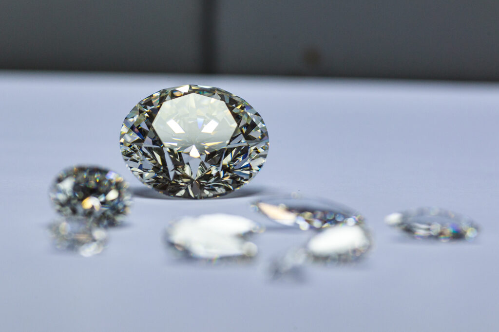 Apply for a Diamond Licence, Sparkling loose diamonds displayed on a table, relevant for diamond license applications.